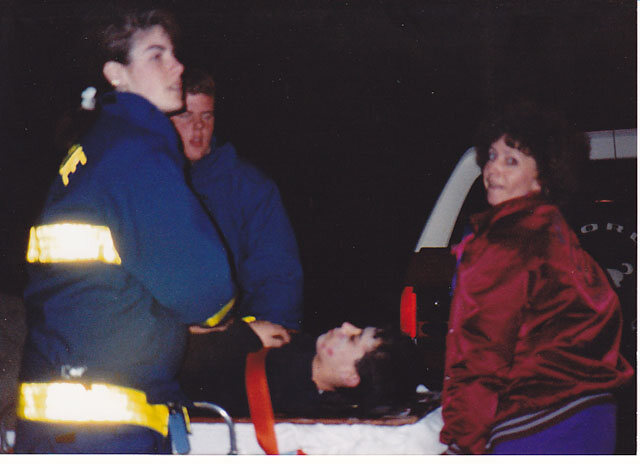 Archival photo of a Mahwah crew member tending to a patient on a stretcher at night