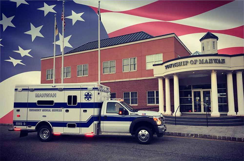 Mahwah EMS ambulance parked in front of the Township building with an American flag
