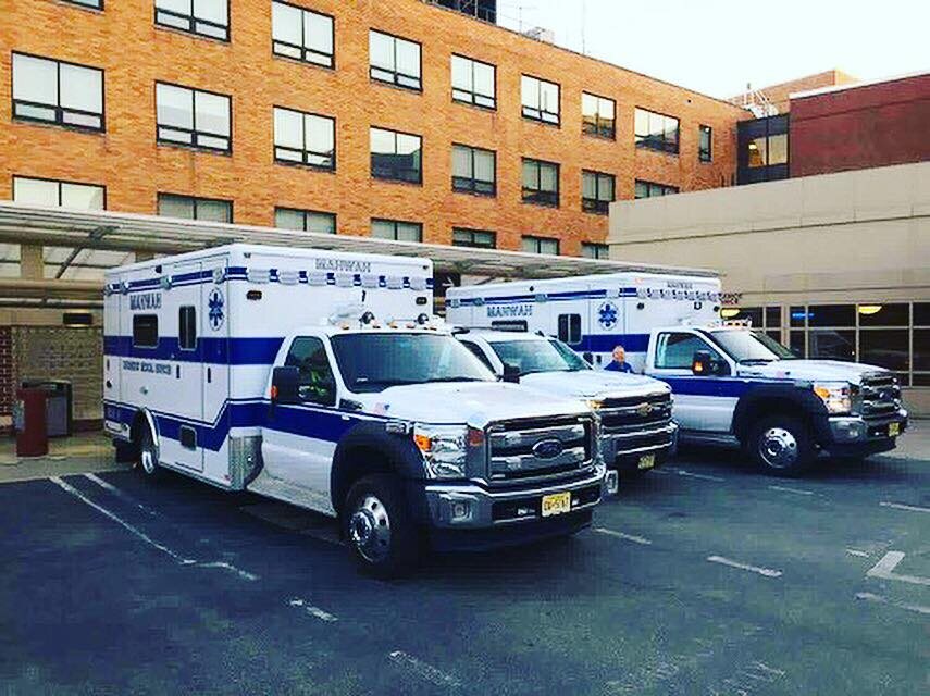 Three Mahwah EMS ambulances parked outside a hospital