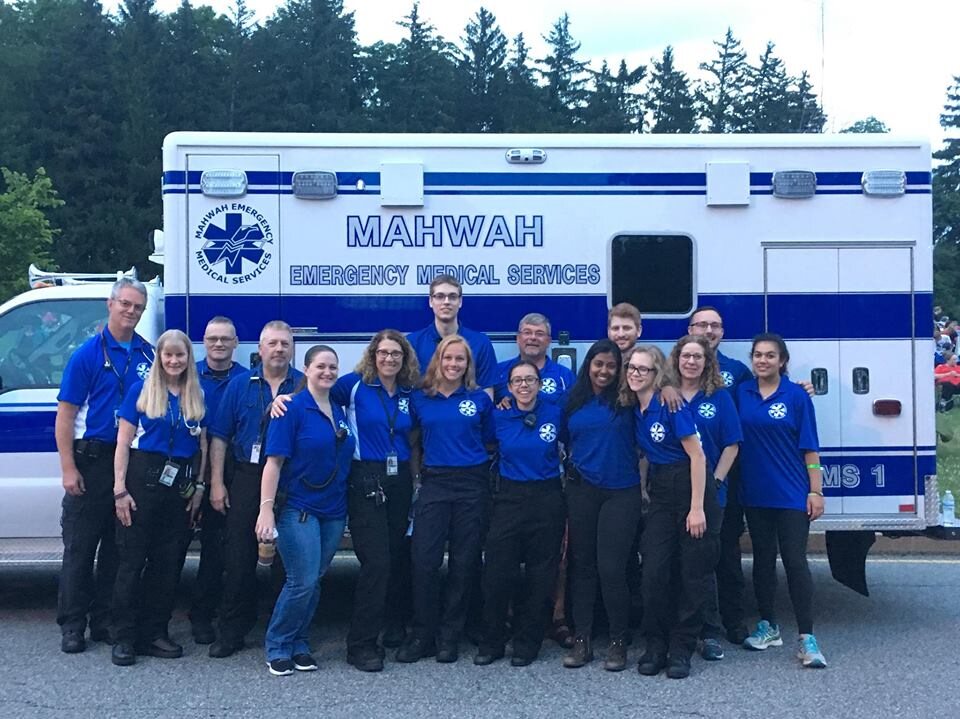 Mahwah EMS crew members posing together in front of an ambulance